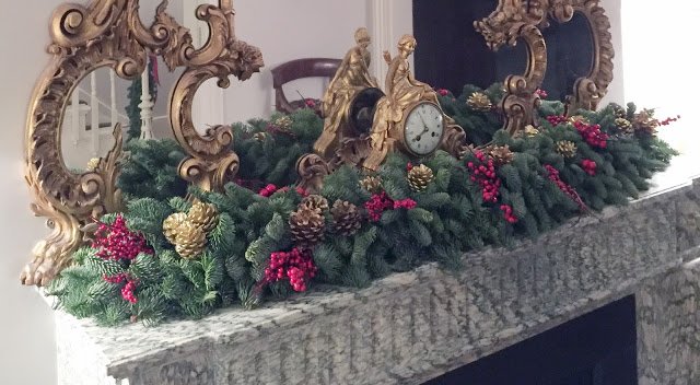 a christmas wreath with gold ornaments and pine cones