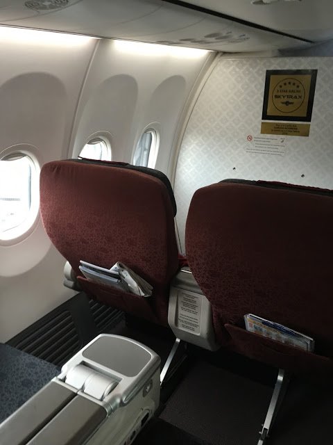 a plane with red seats and a white table