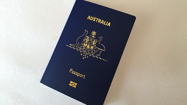 a blue passport with gold text
