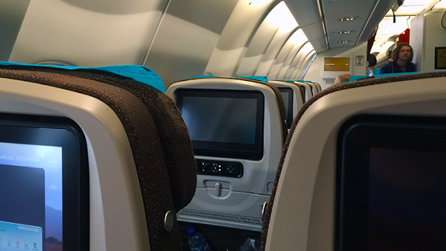 seats in an airplane with a television screen