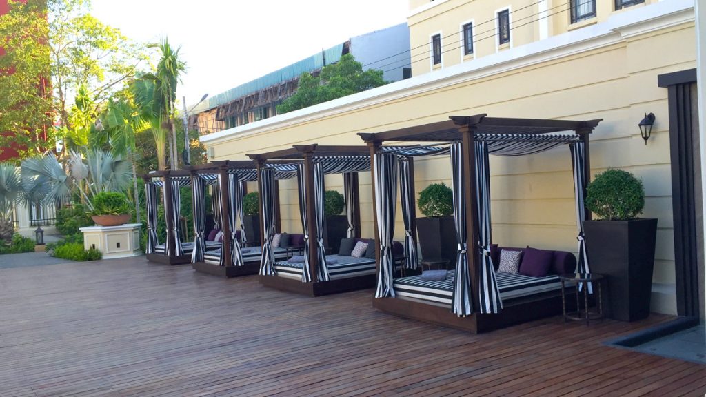 a group of beds with curtains on a deck