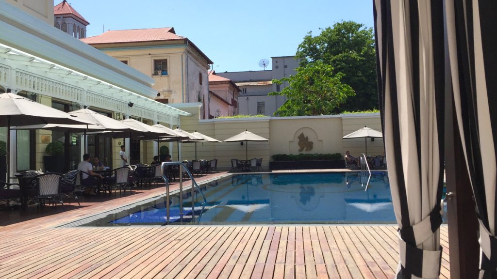 a pool with umbrellas and chairs