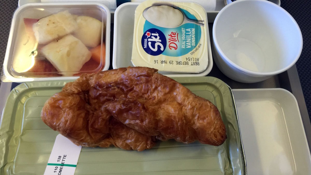 a croissant and a container of yogurt