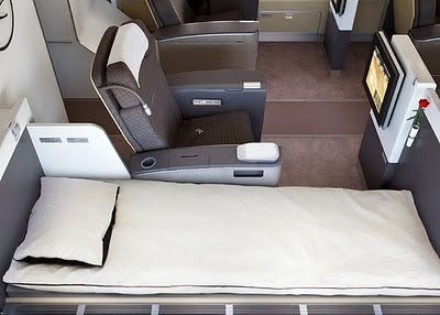 a bed and a tv in a plane