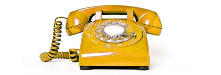 a yellow rotary telephone with a cord