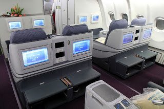 a row of seats with monitors on the side