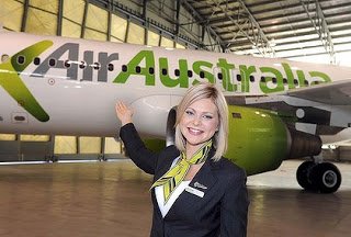 a woman in a suit standing in front of a plane