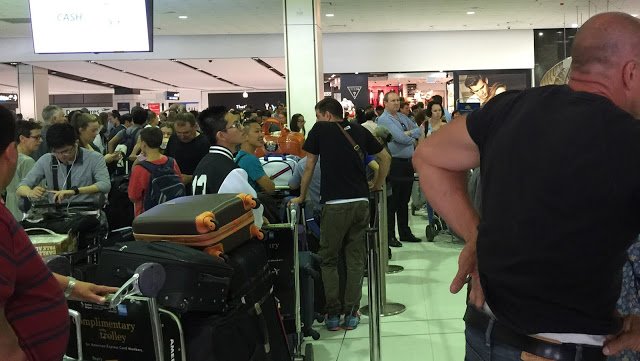 a group of people in a line at an airport