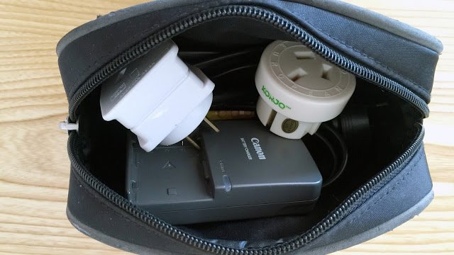 a bag with a couple of adapters and a charger