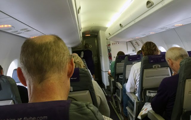 a group of people sitting in an airplane