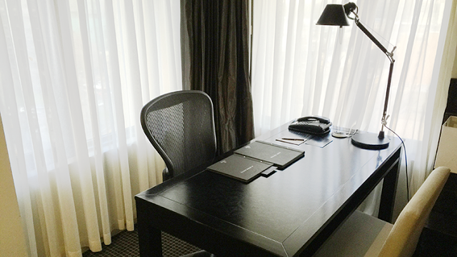 a desk with a telephone and papers on it