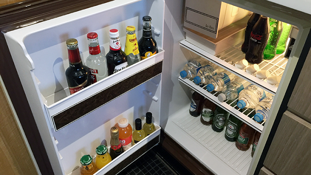 a refrigerator with bottles of drinks