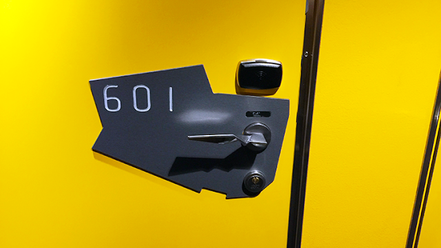 a door handle and lock on a yellow wall