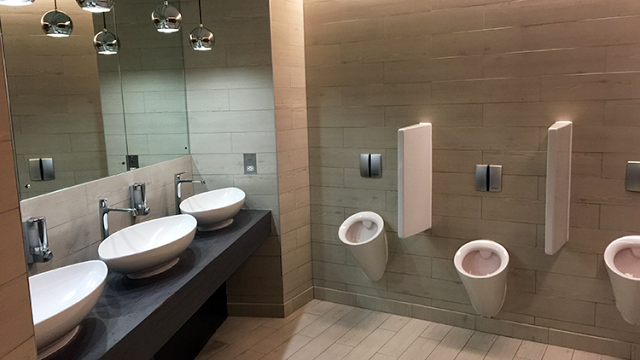 a bathroom with urinals and sinks