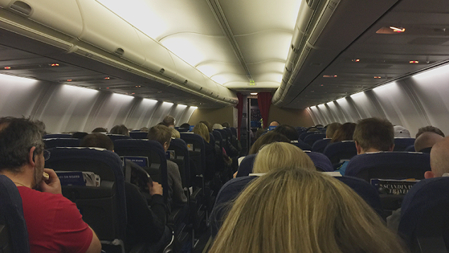 a group of people sitting in an airplane