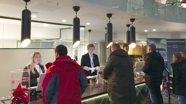 a group of people standing around a counter