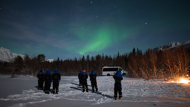 a group of people standing in snow