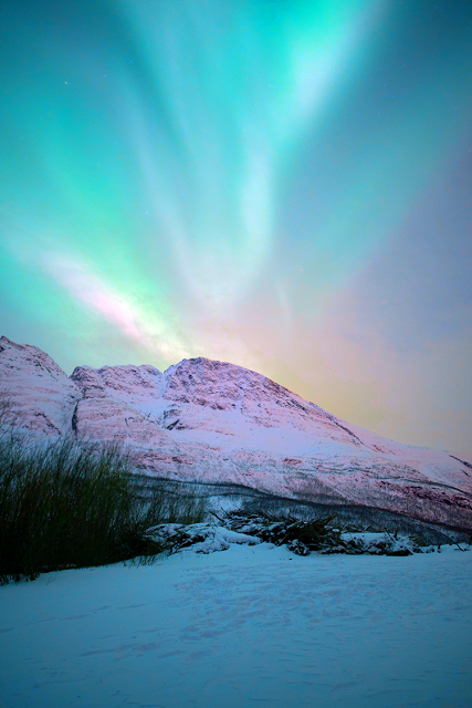 a snowy mountain with a blue sky and clouds