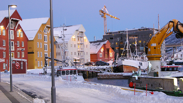 a snowy city with boats and buildings