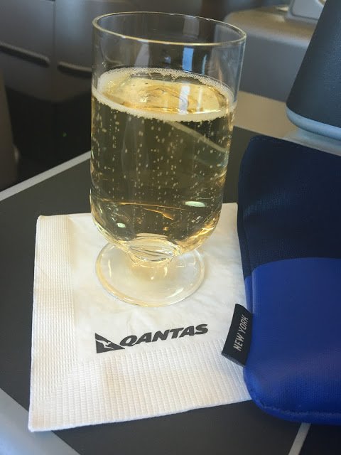 a glass of champagne on a napkin