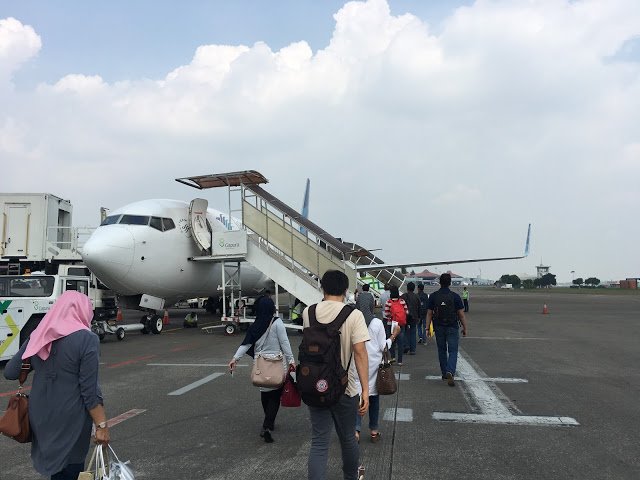 people walking around an airplane