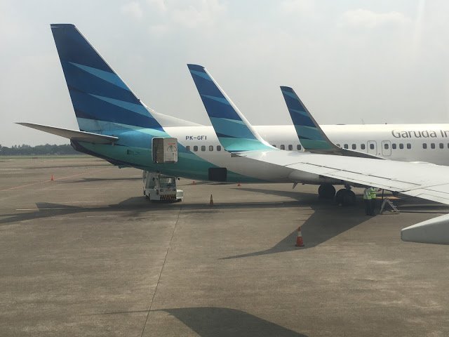 a group of airplanes parked on a tarmac