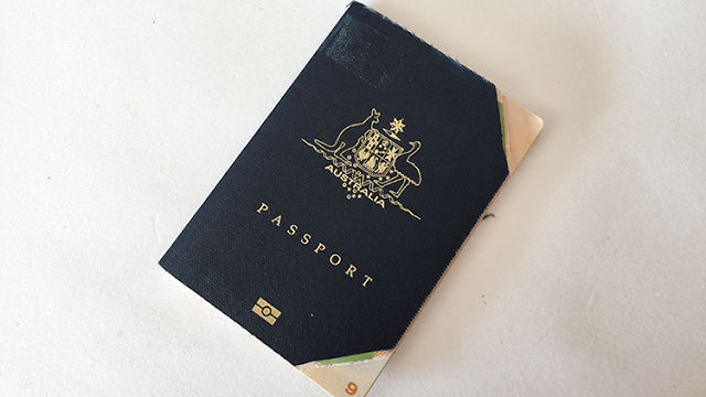 a black passport with gold text