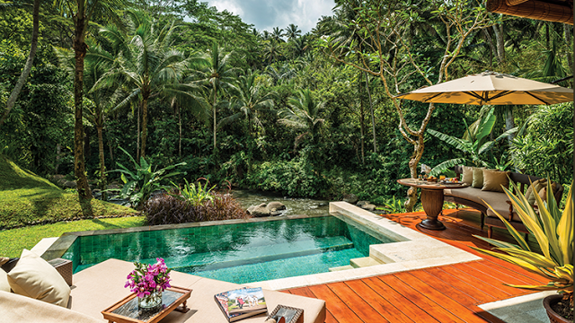 a pool with a deck and a table and chairs