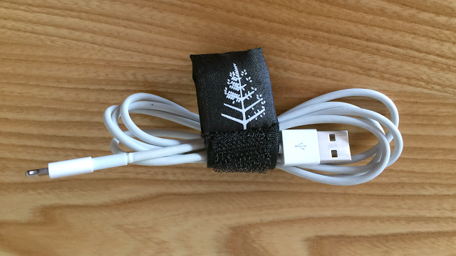 a white cord wrapped in a black fabric