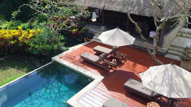 a pool with lounge chairs and umbrellas