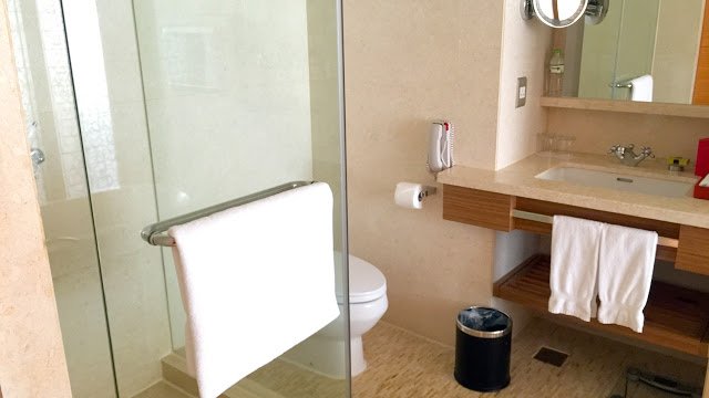 a bathroom with a glass shower door