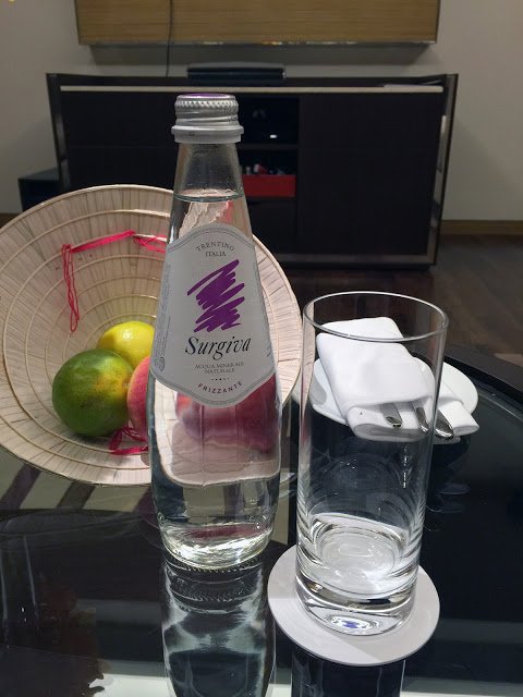 a bottle of water and a glass on a table