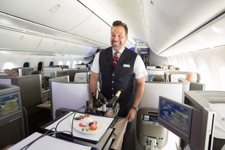 a man in a uniform standing in an airplane