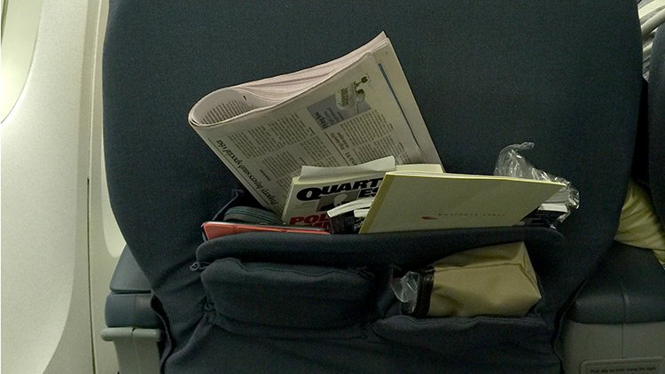 a bag with a newspaper and other objects in it