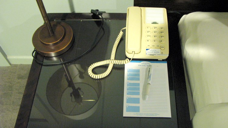 a telephone and a pen on a desk