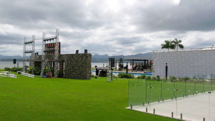 a large lawn with a pool and a building