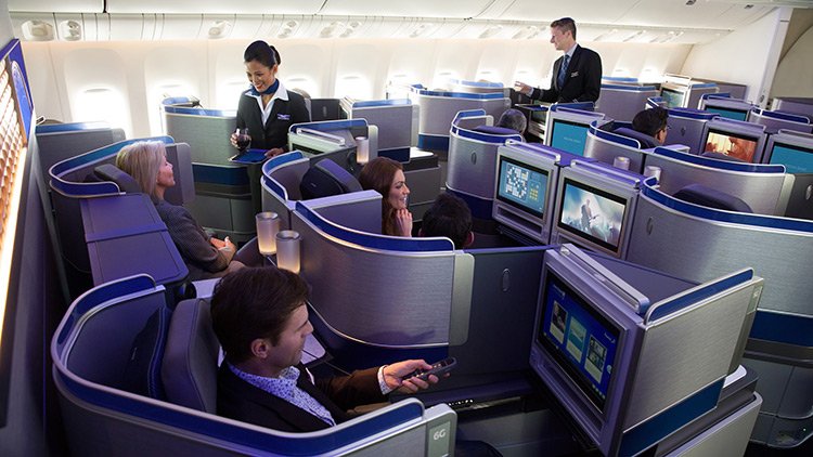 a group of people sitting in chairs in a plane