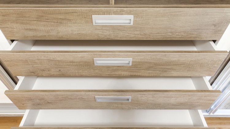 a wooden drawers with white handles