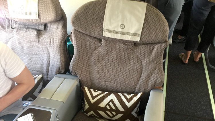 a seat with a pillow on the back