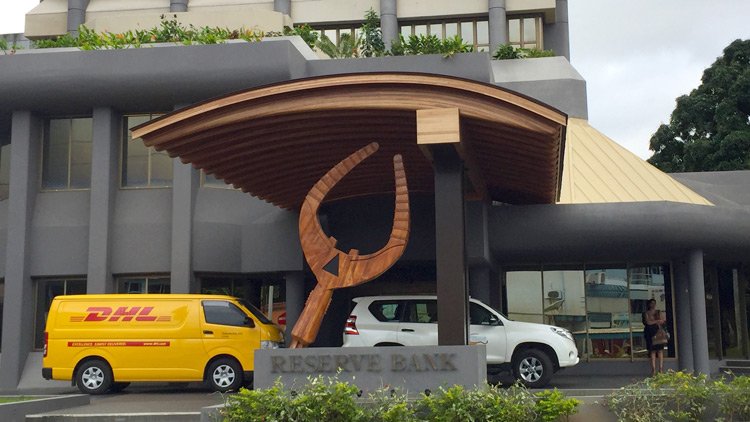 a large wooden sculpture in front of a building