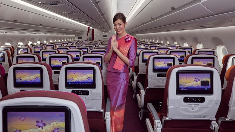 a woman in a purple dress standing in a row of seats