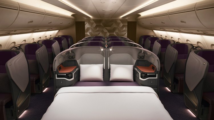 a bed and chairs in a plane