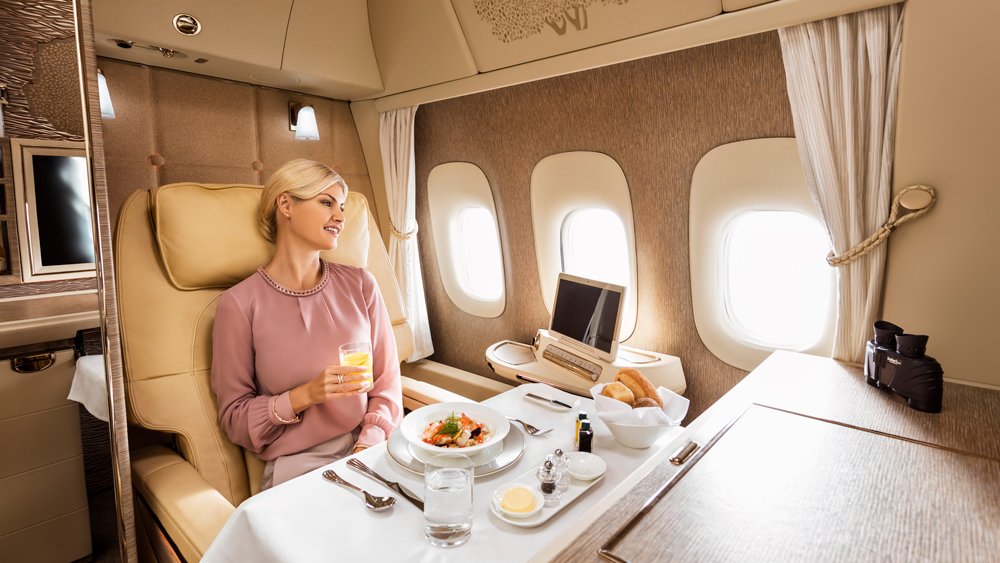 a woman sitting in a chair in a plane