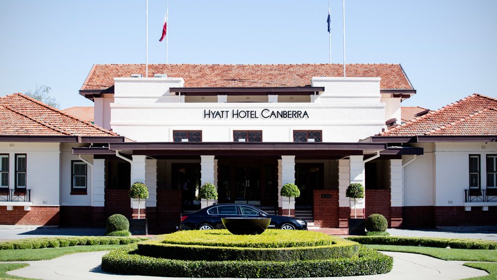 a car parked in front of a hotel