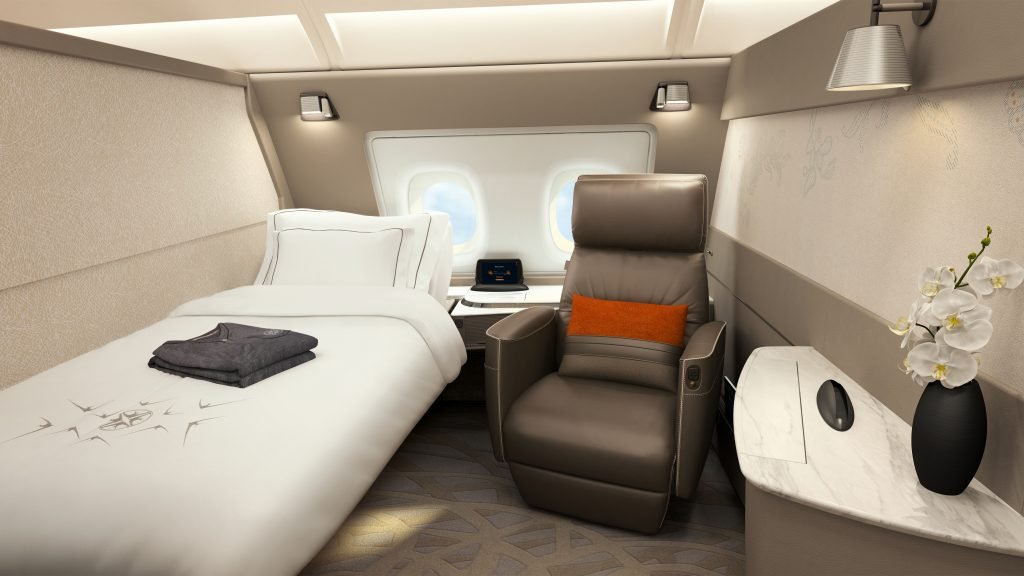 a bed and chair in a plane