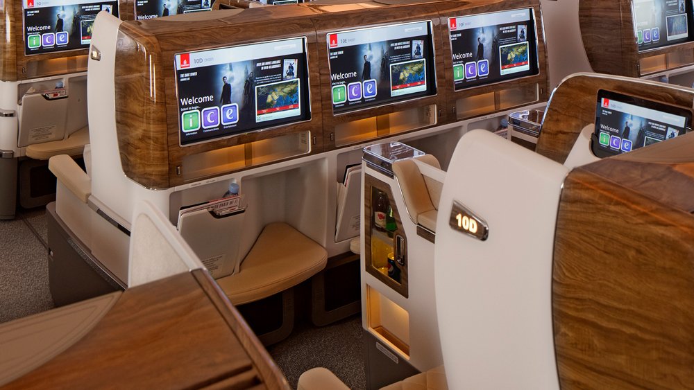 a row of tv screens in an airplane