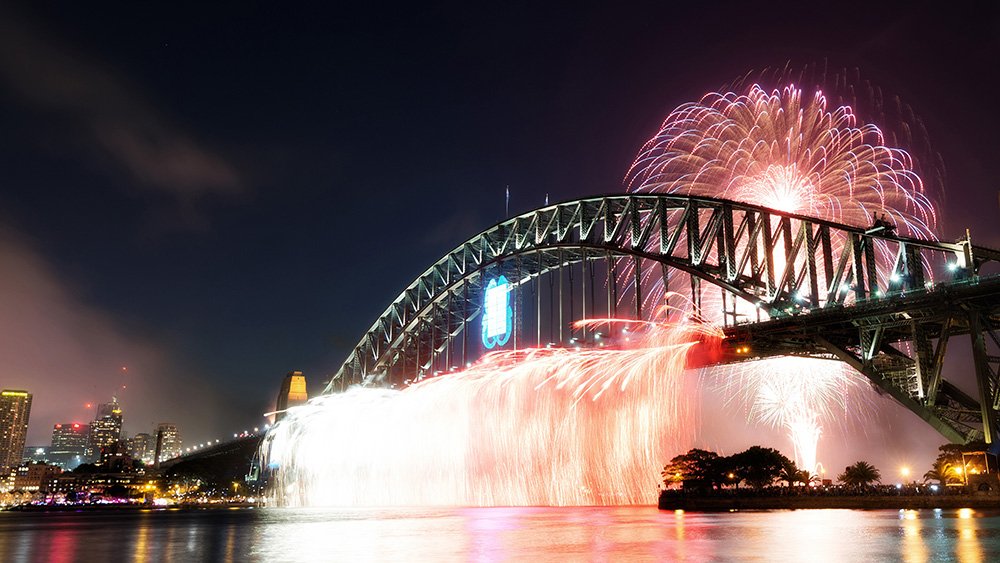 a bridge with fireworks over it