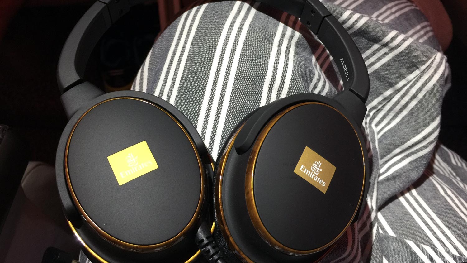 a pair of black headphones on a striped fabric