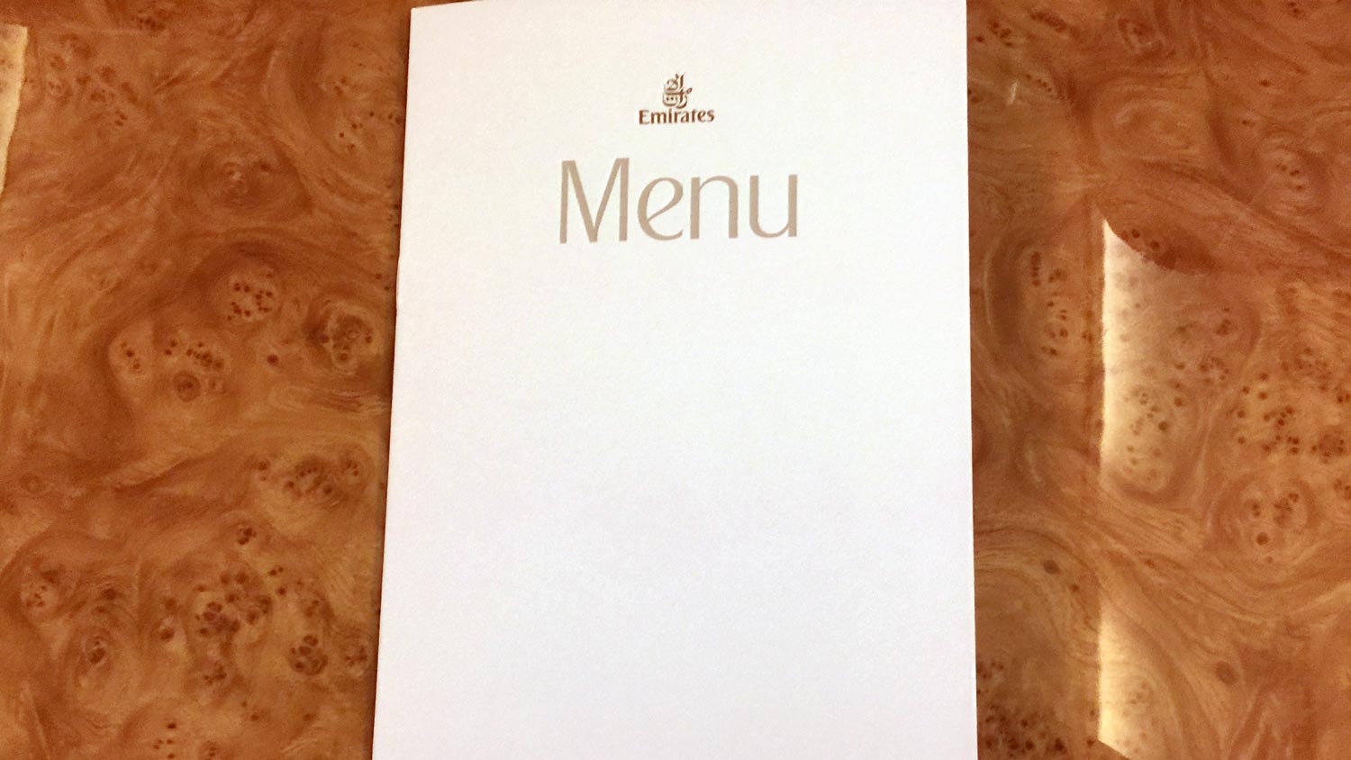 a white menu on a wooden surface