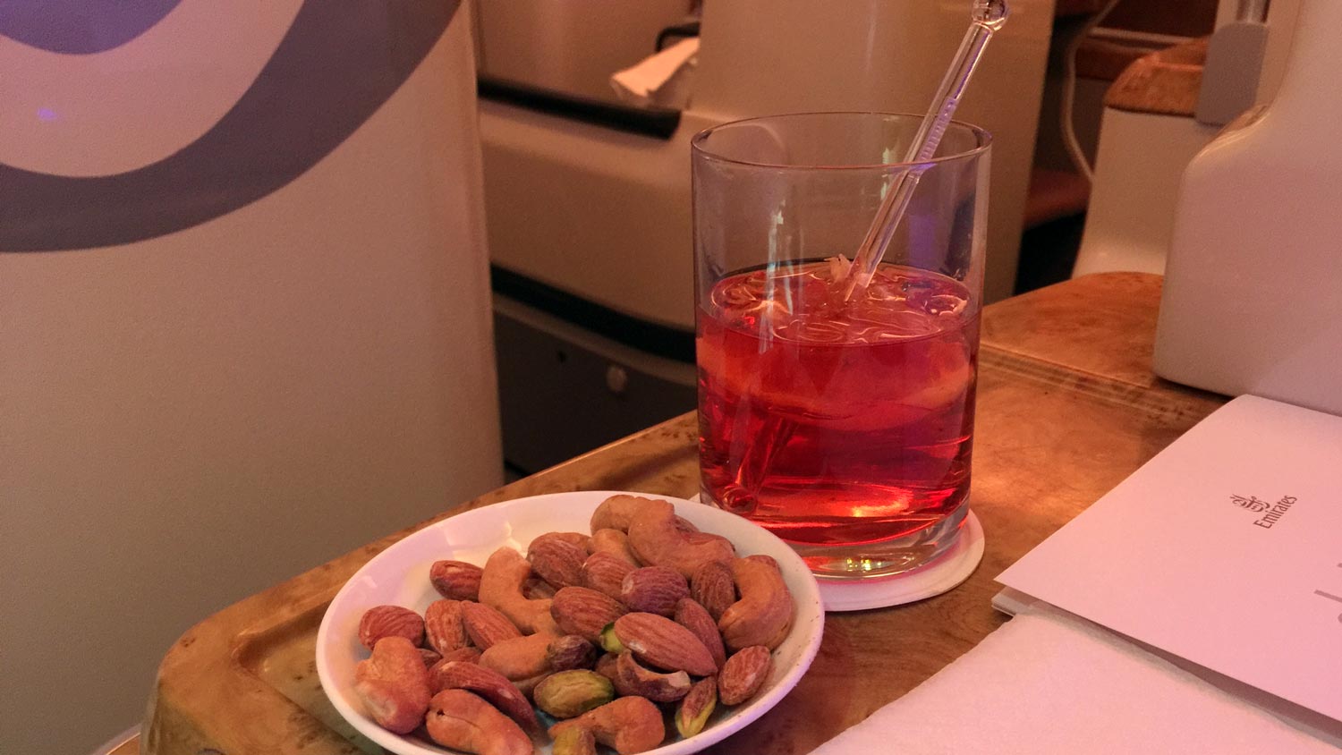 a plate of nuts and a drink on a table